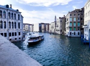 A boat floating down the grand canal in Venice, Italy.