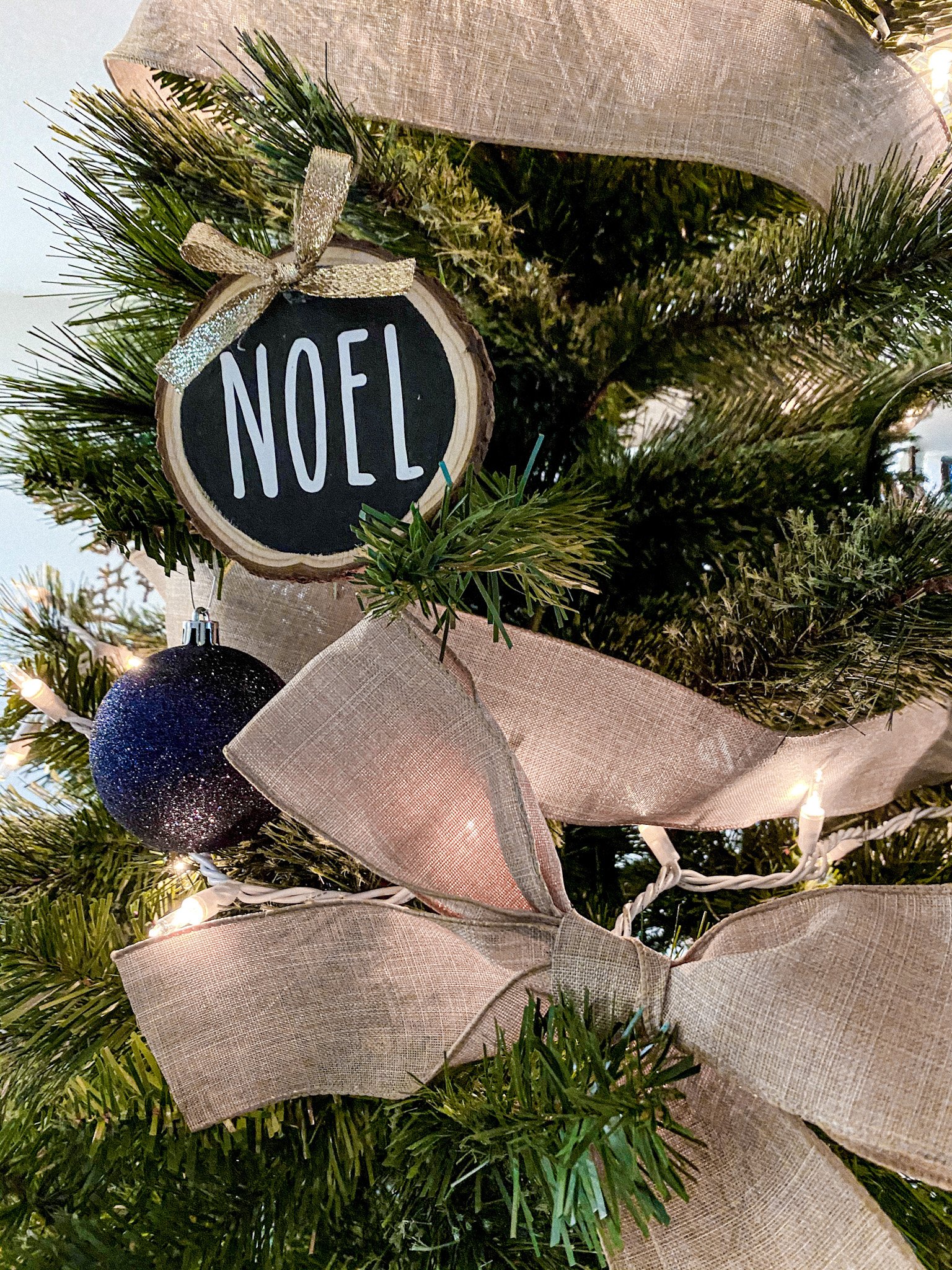 DIY wood slice ornament on a tree